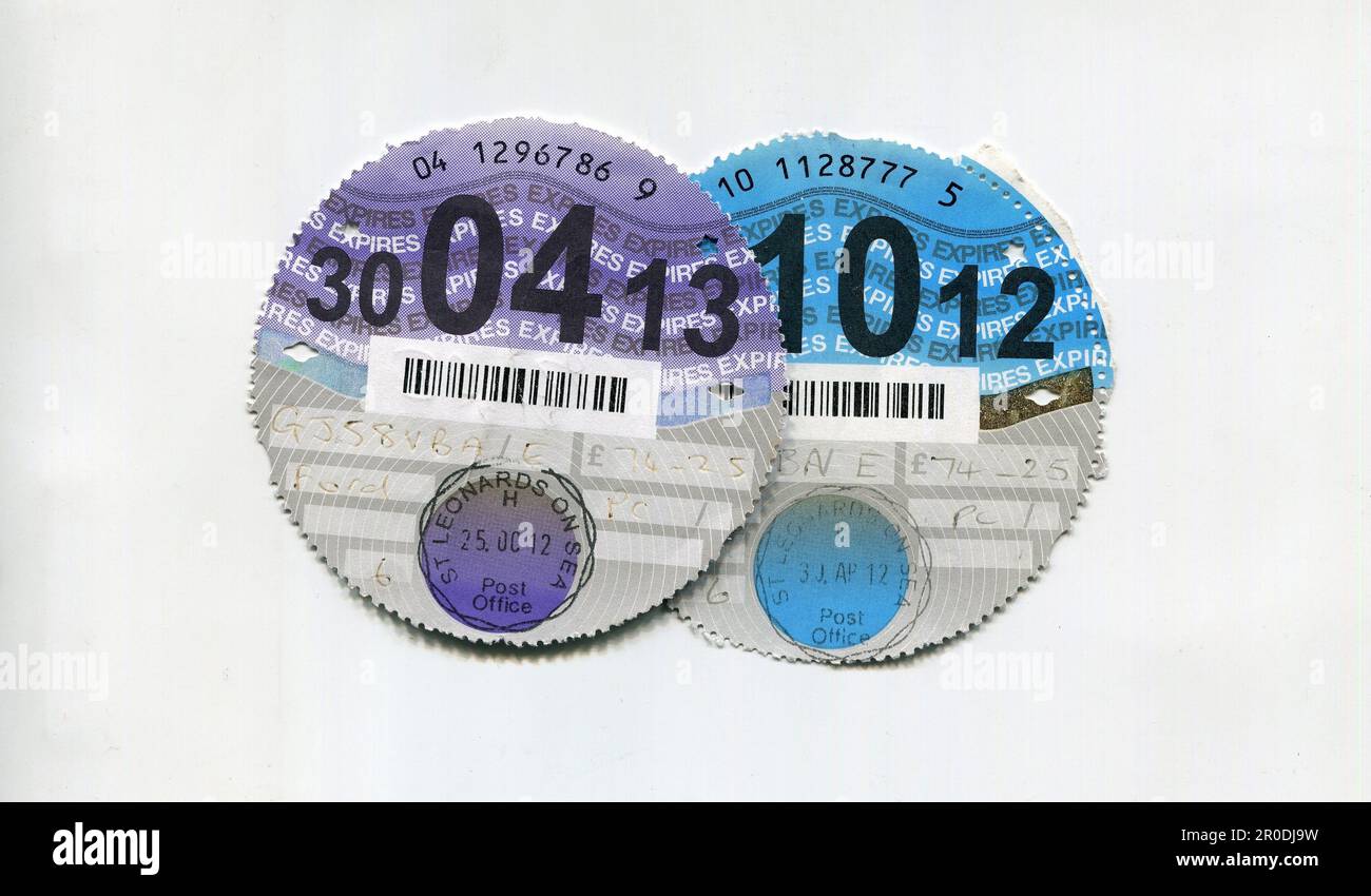 Old UK paper vehicle tax disks which used to be displayed on the windscreen to prove that excise duty had been paid. The disks were discontinued in 2014 in favour of computerised checks. Stock Photo