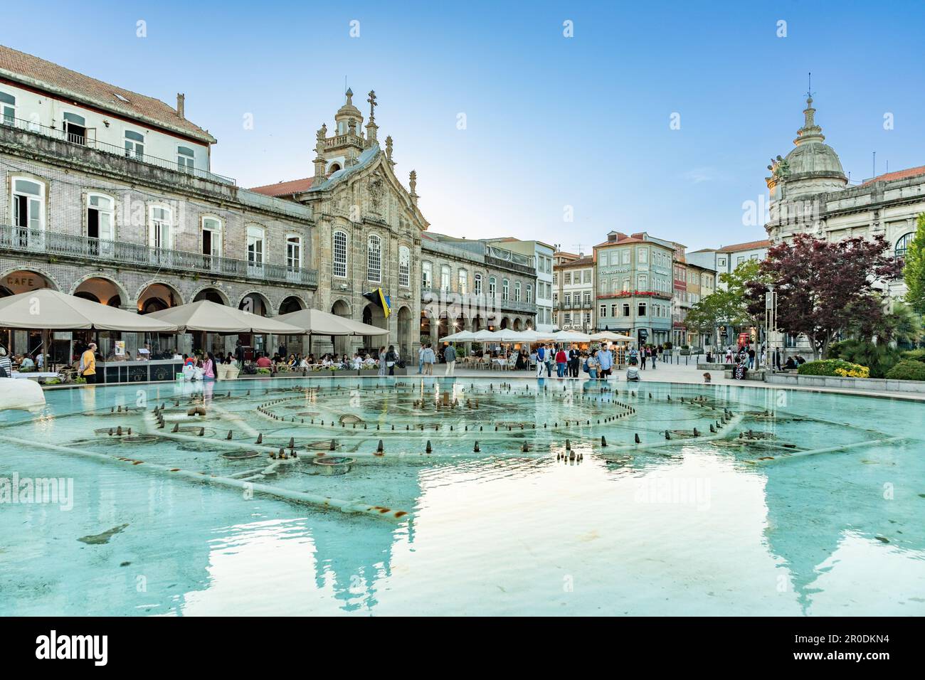 Braga, Portugal - April 30, 2023: sunset view of Praca da Republica in the historical center of Braga, Portugal with reflection in fountain. Stock Photo