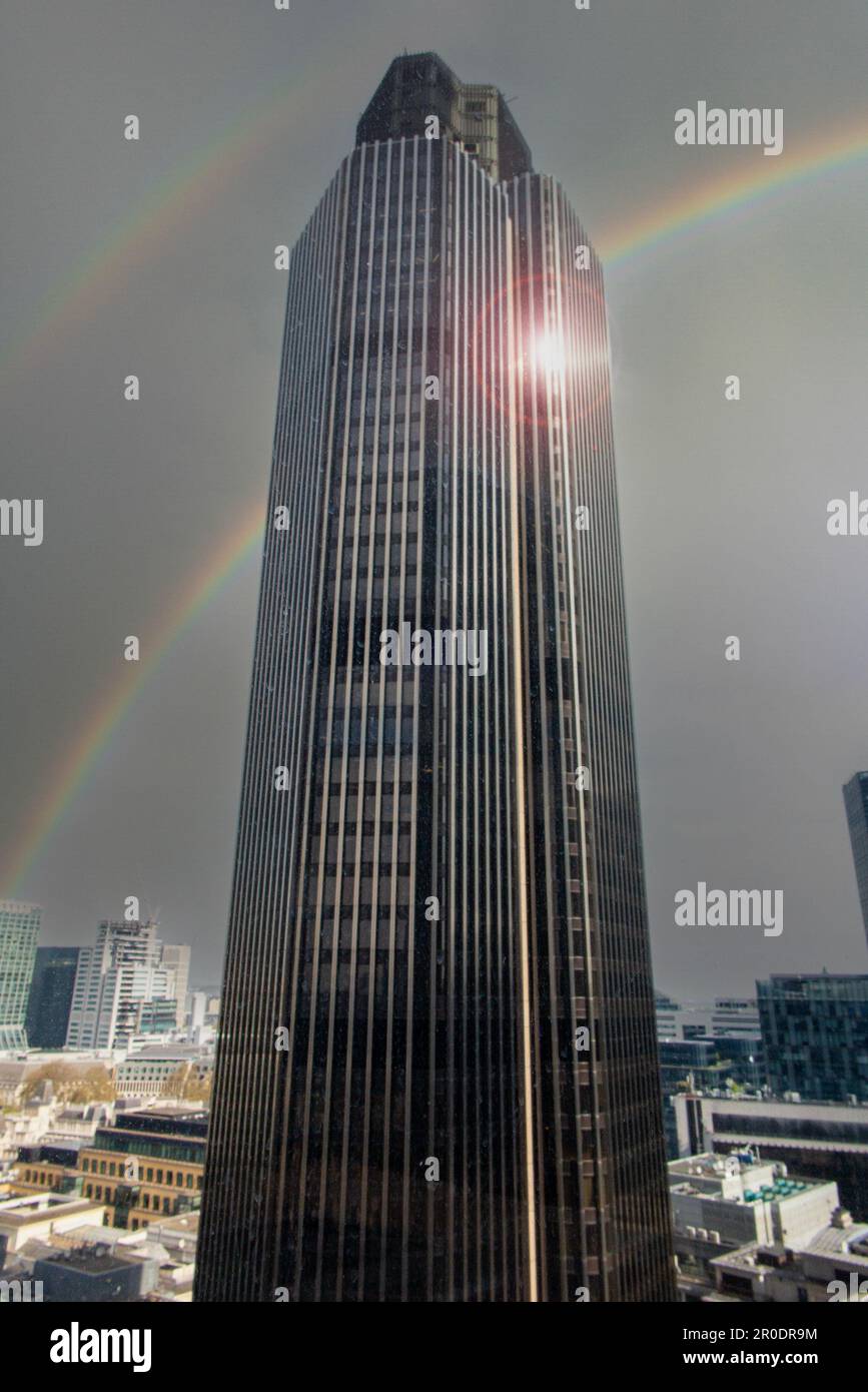 Tower 42 under a dark sky and a rainbow Stock Photo