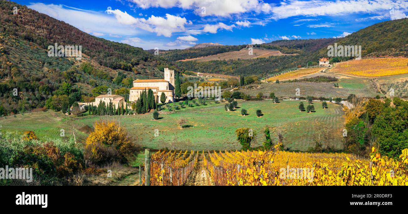 Italy, Toscana autumn scenery . Golden vineyards of Tuscany.  panorama of old monastery and yellow grapewines. Stock Photo