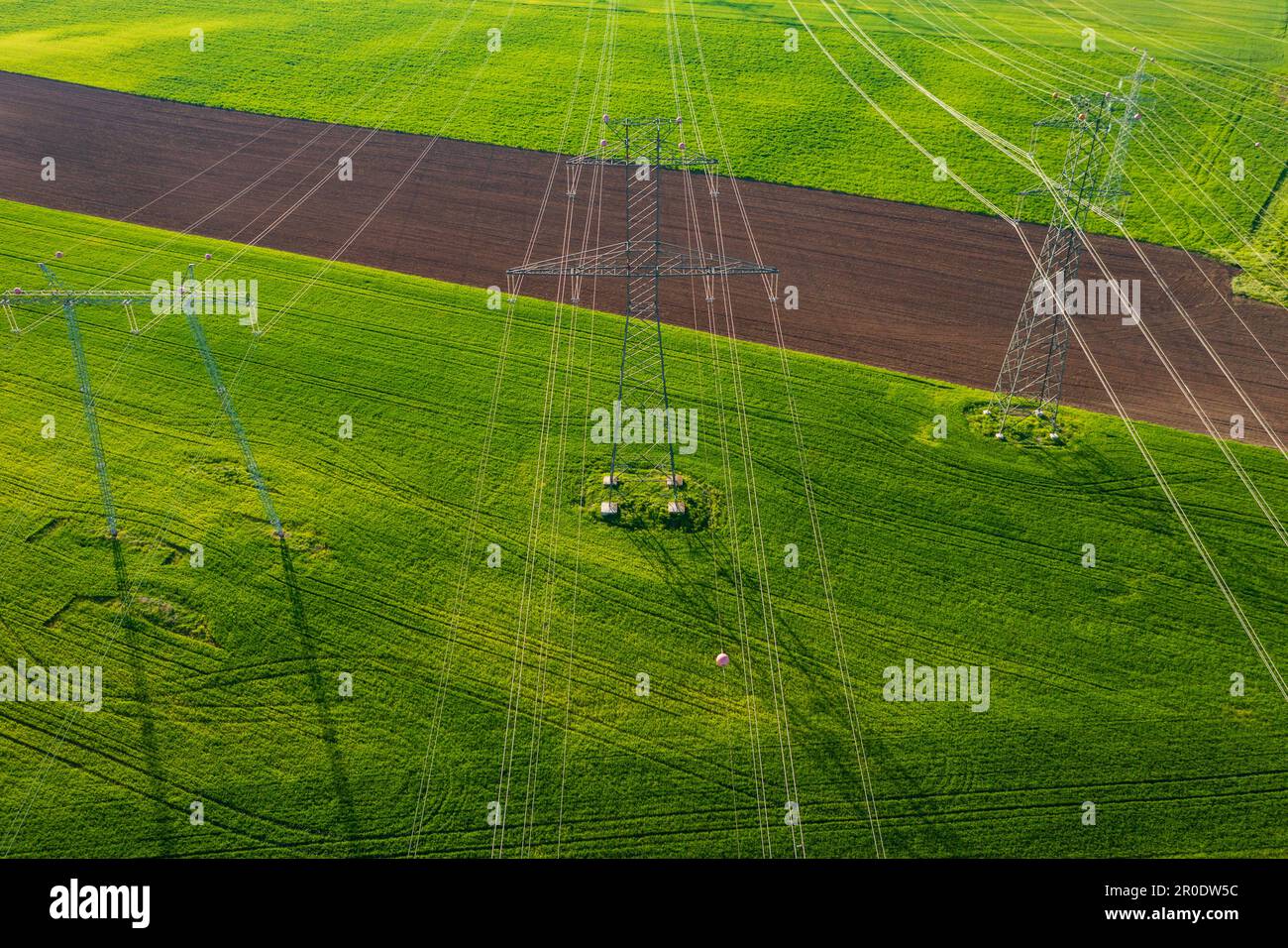 Aerial close-up view of electricity pylon with power lines over ...