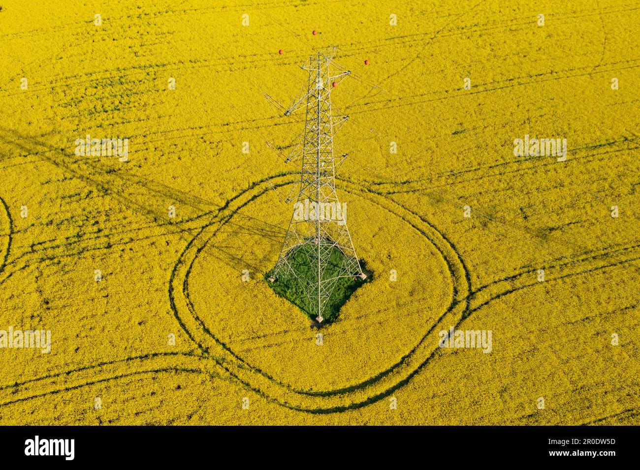 Aerial view of electricity pylon with power lines over agricultural ...