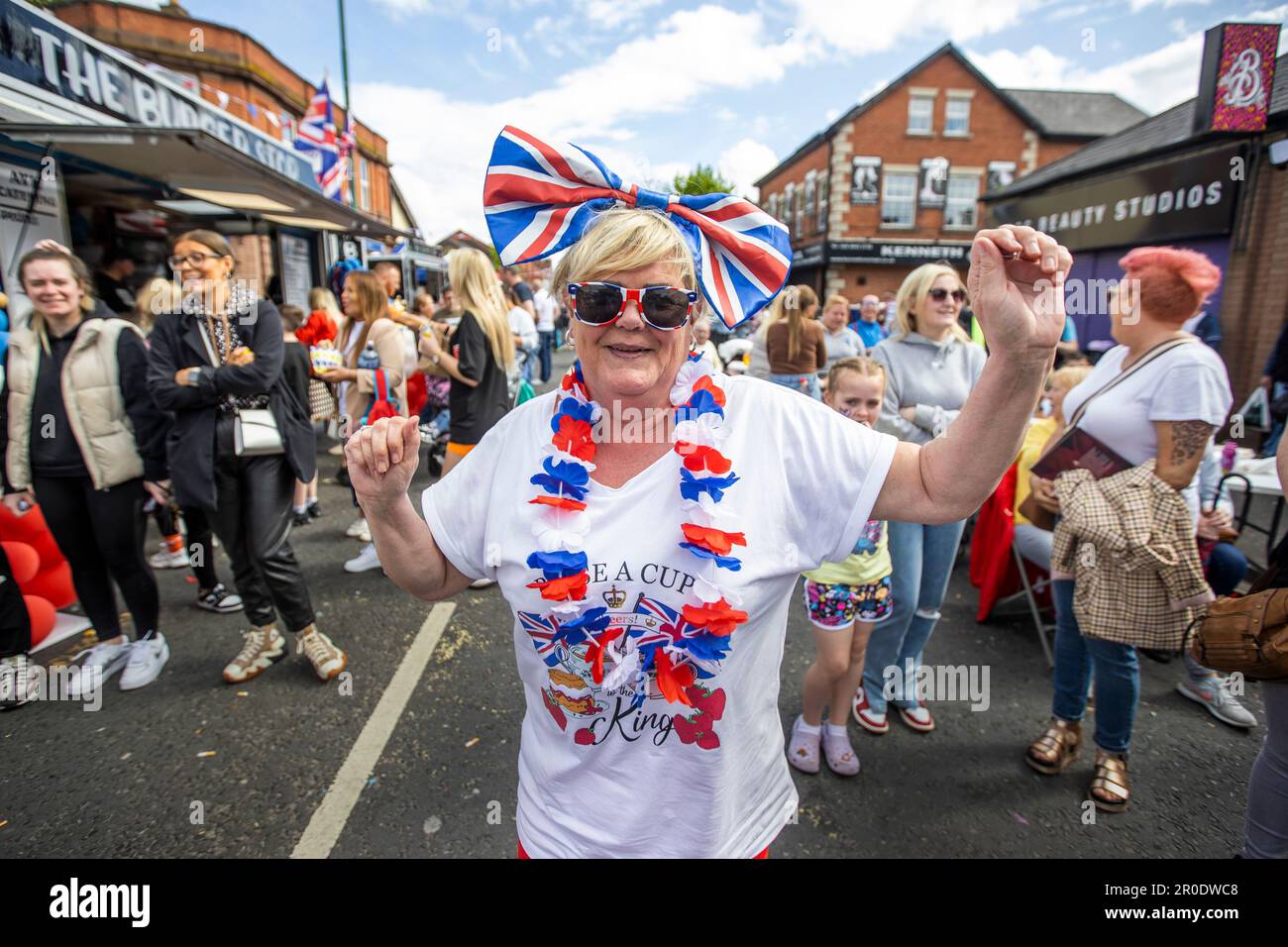 Elizabeth Sewell dancing on the Woodstock Road in east Belfast during the Kings Coronation Festival. Picture date: Monday May 08 2022. Stock Photo