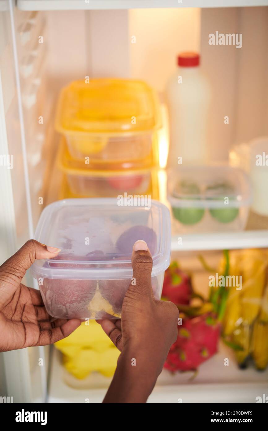 https://c8.alamy.com/comp/2R0DWF9/woman-organizing-food-storage-in-her-fridge-putting-everything-into-containers-2R0DWF9.jpg