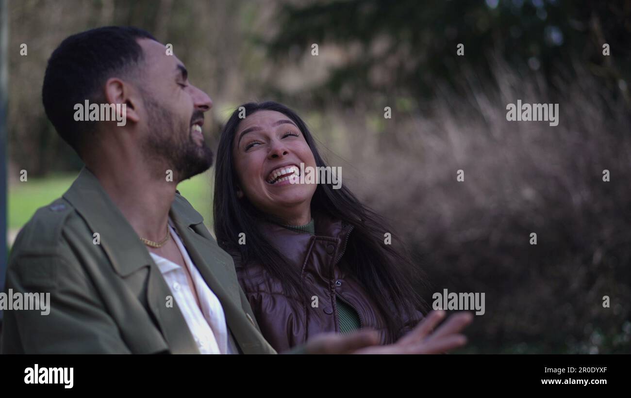 A Candid Joyful Young Arab Couple Laughing And Smiling Together While A Candid Joyful Young Arab Couple Laughing And Smiling Together While