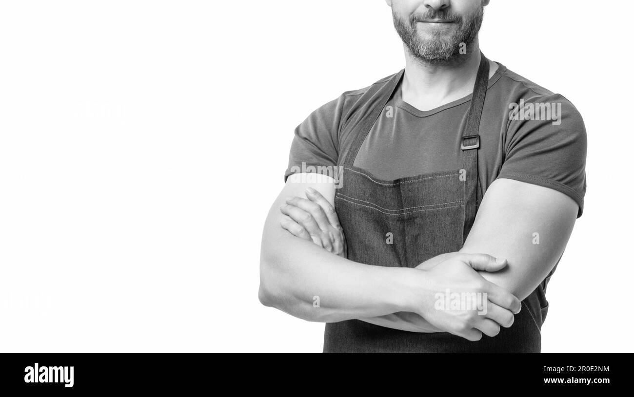 cropped view of man in apron isolated on white background. crossed hands Stock Photo