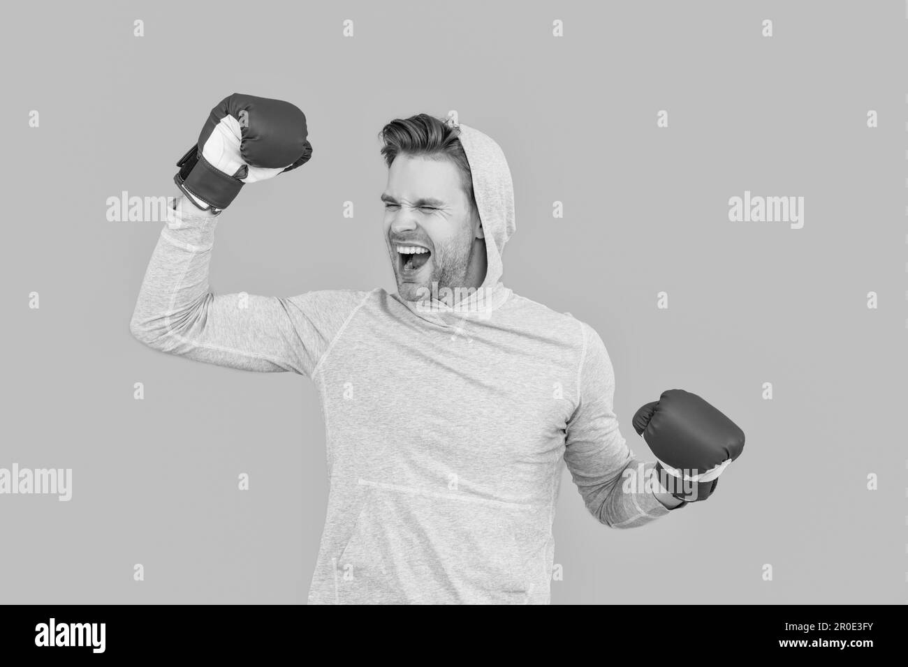 Boxer fighter making winning gesture in boxing gloves. Boxer man happy