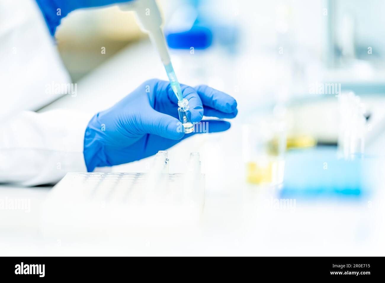 Scientist pipetting sample into test tube during experiment lab hi-res ...