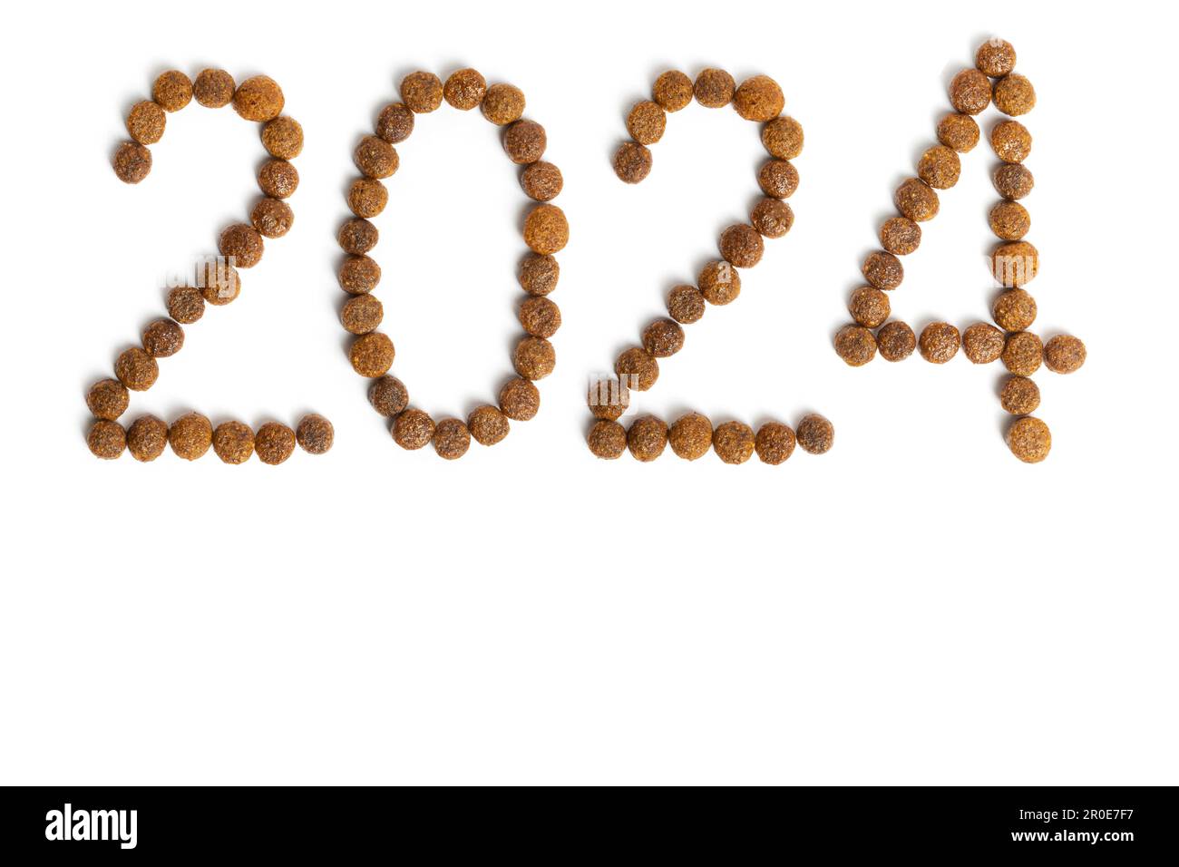 Calendar 2024 from Dry pet food on a white background. Granules of good nutrition for dogs and cats. Food for the animals. Brown homogeneous pieces of Stock Photo