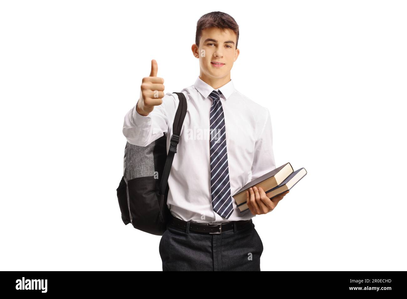 Teenage male student holding books and showing thumbs up isolated on ...