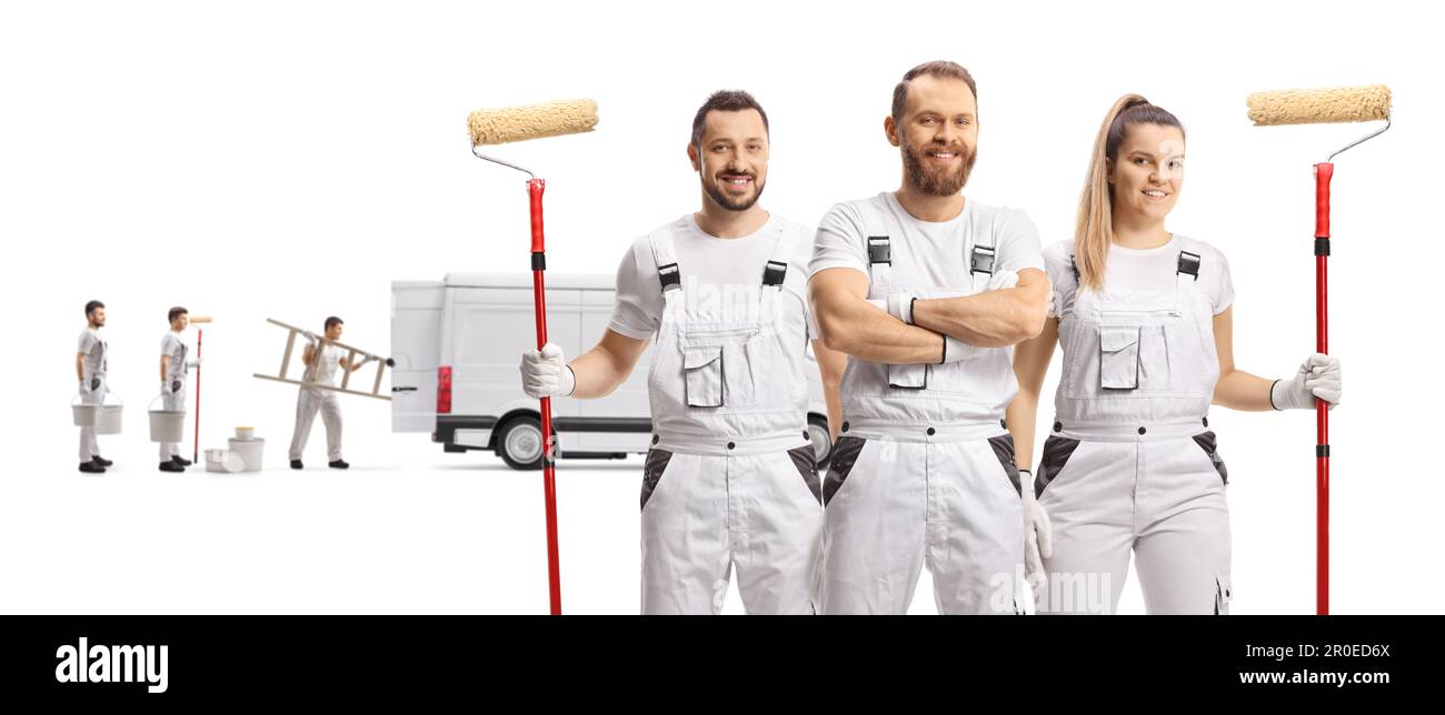 Team of professional painters posing and other coworkers loading a van isolated on white background Stock Photo