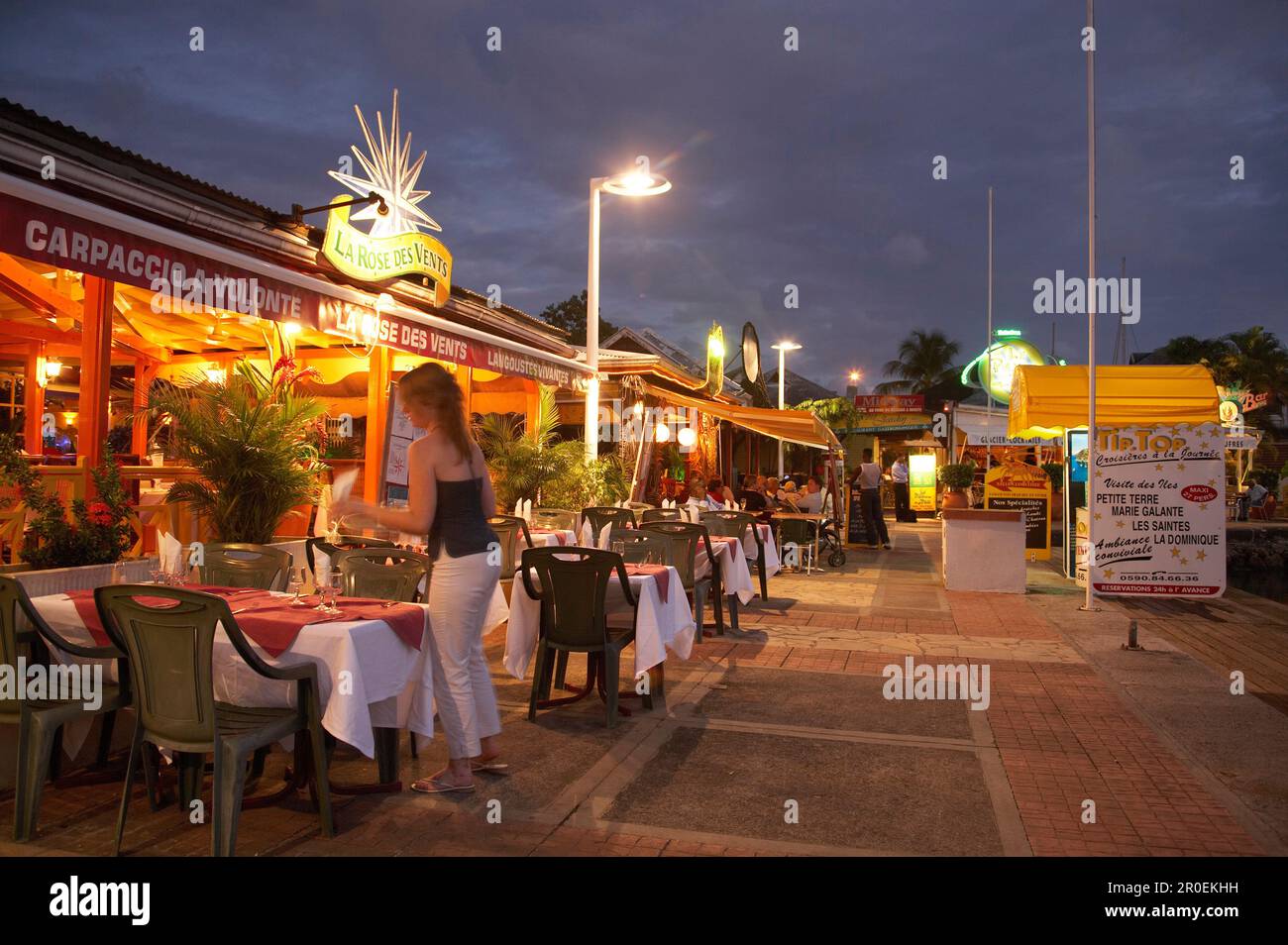 Restaurants in the evening light, tables along the Marina, Le Gosier, Pointe-a-Pitre, Grande Terre, Guadeloupe, Caribbean Sea, America Stock Photo