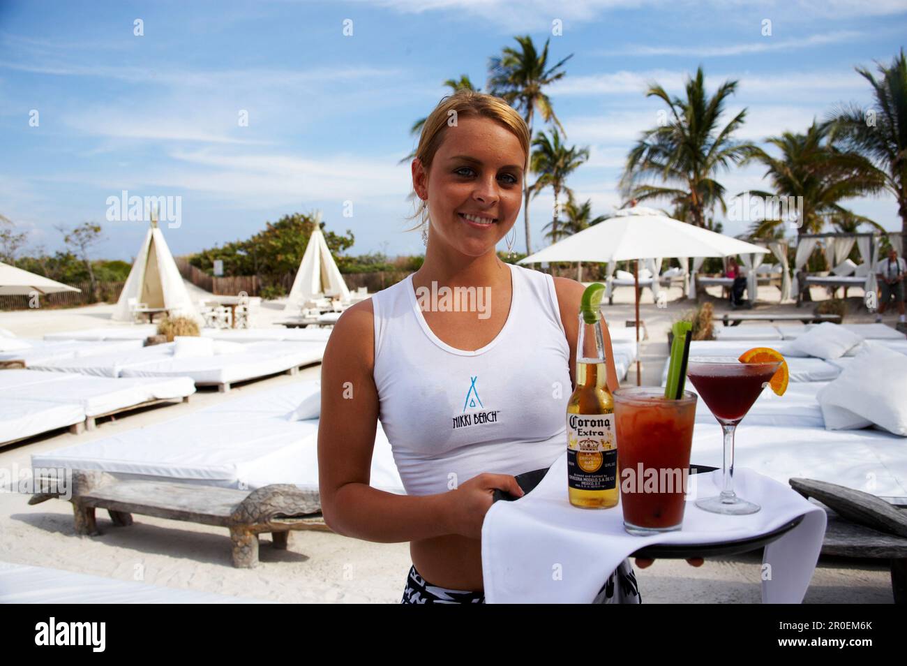 Waitress with cocktails at Nikki Beach Club, South Beach, Miami, Florida, USA, America Stock Photo