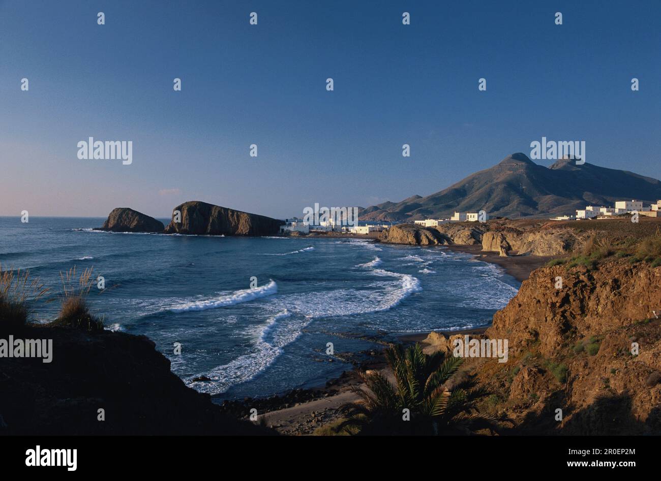 View at village at the coast in the sunlight, Playa del Peno Blanco, Cabo de Gata, Andalusia, Spain, Europe Stock Photo