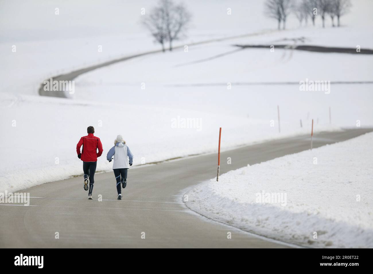 Young couple running on country road Stock Photo