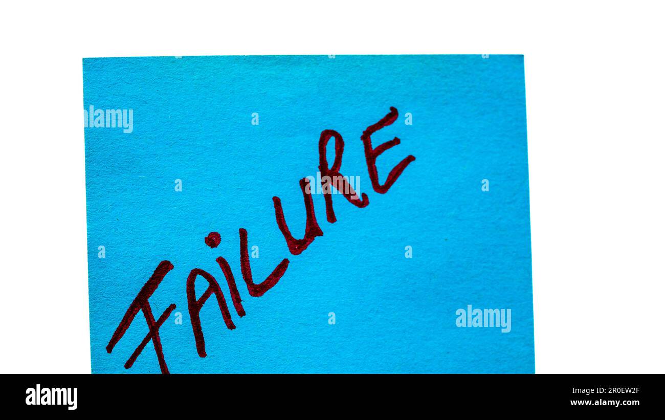 Failure handwriting text close up isolated on blue paper with copy