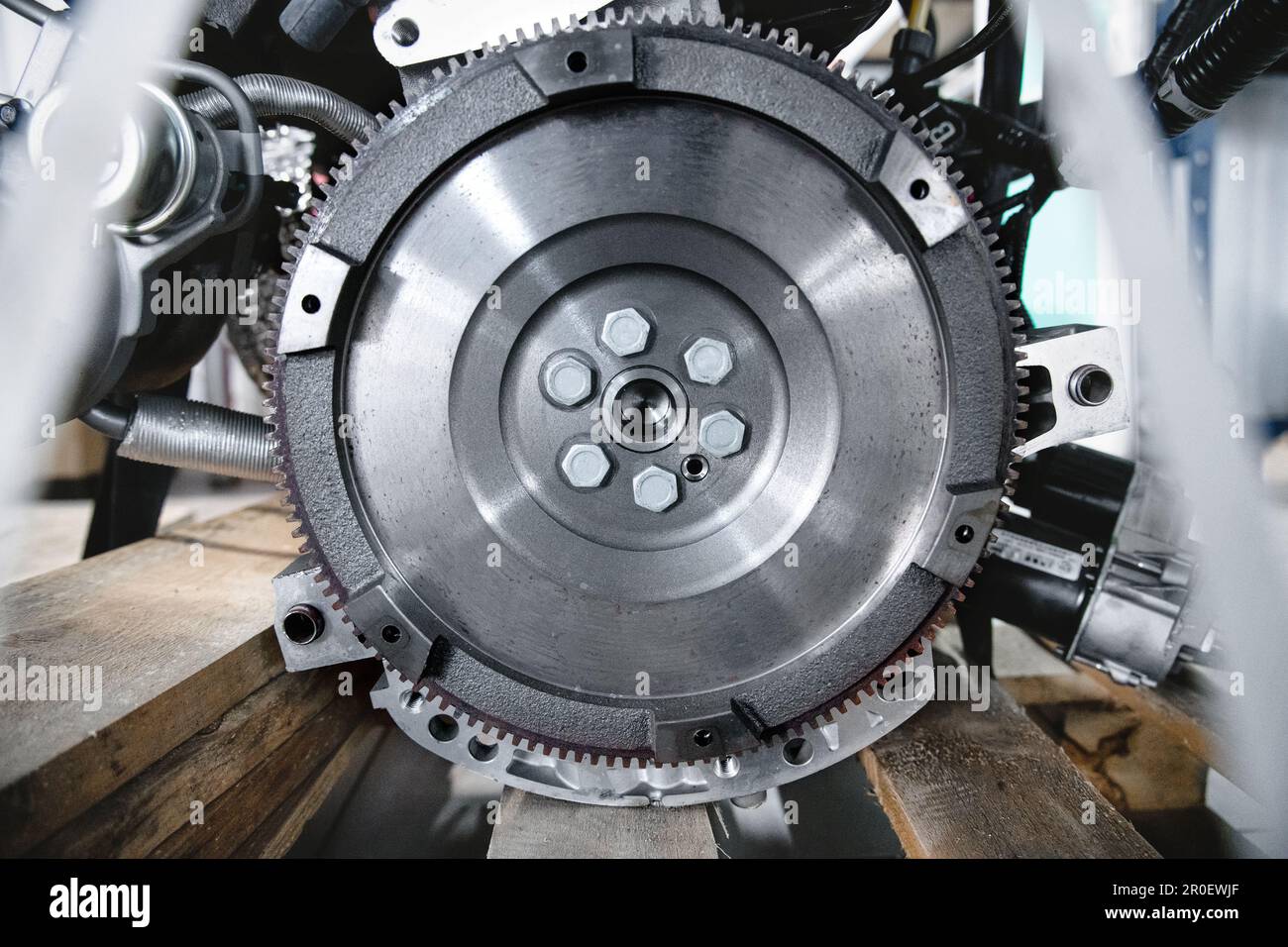 New flywheel mounted on a car engine. Gear detail clutch part Stock