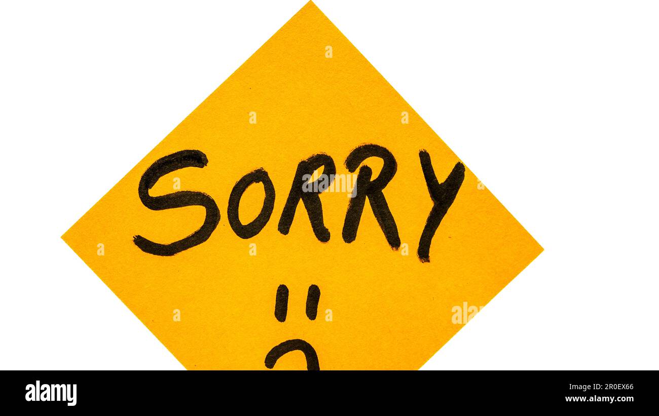 Sorry handwriting text close up isolated on orange paper with copy