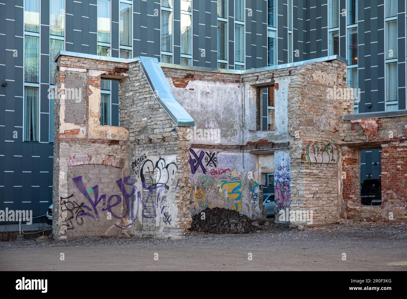 Ruins of an old industrial building against a backdrop of modern commercial building in Rotermanni Quarter of Tallinn, Estonia Stock Photo