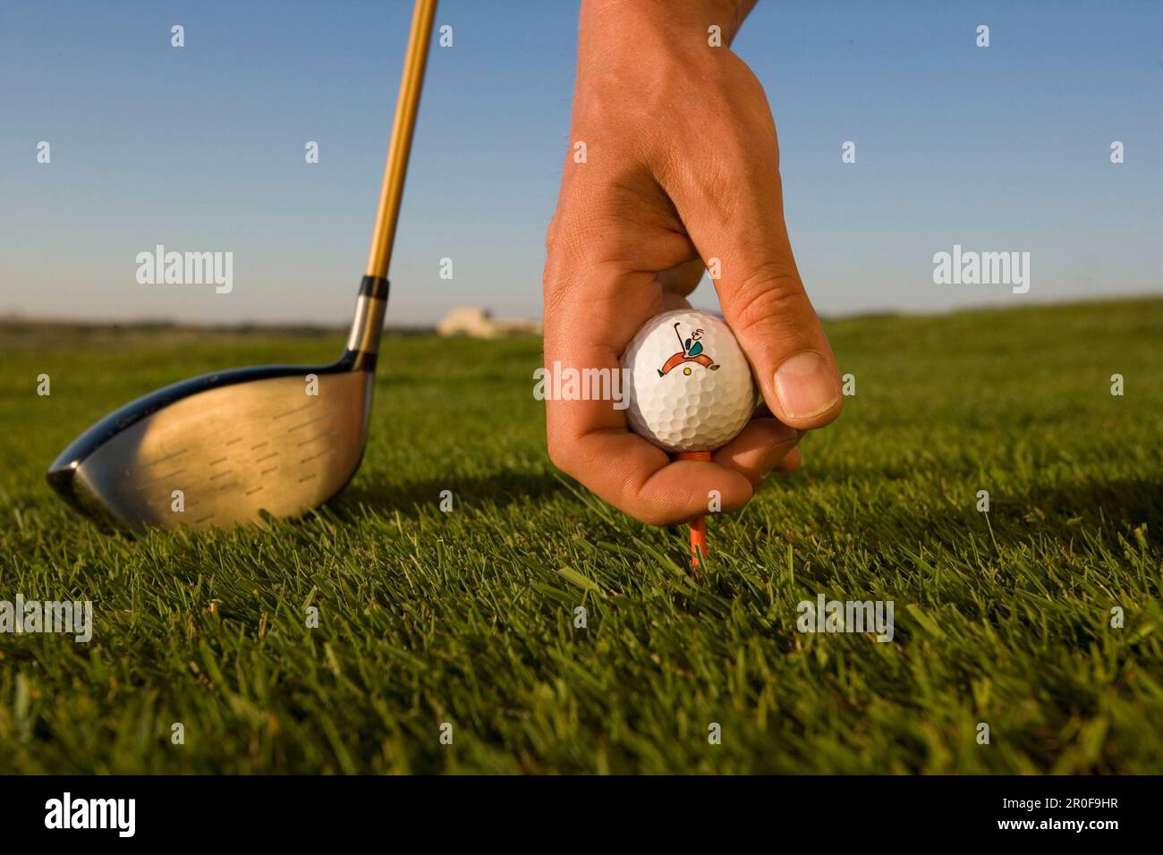 Golf, man placing golf ball on tee Stock Photo