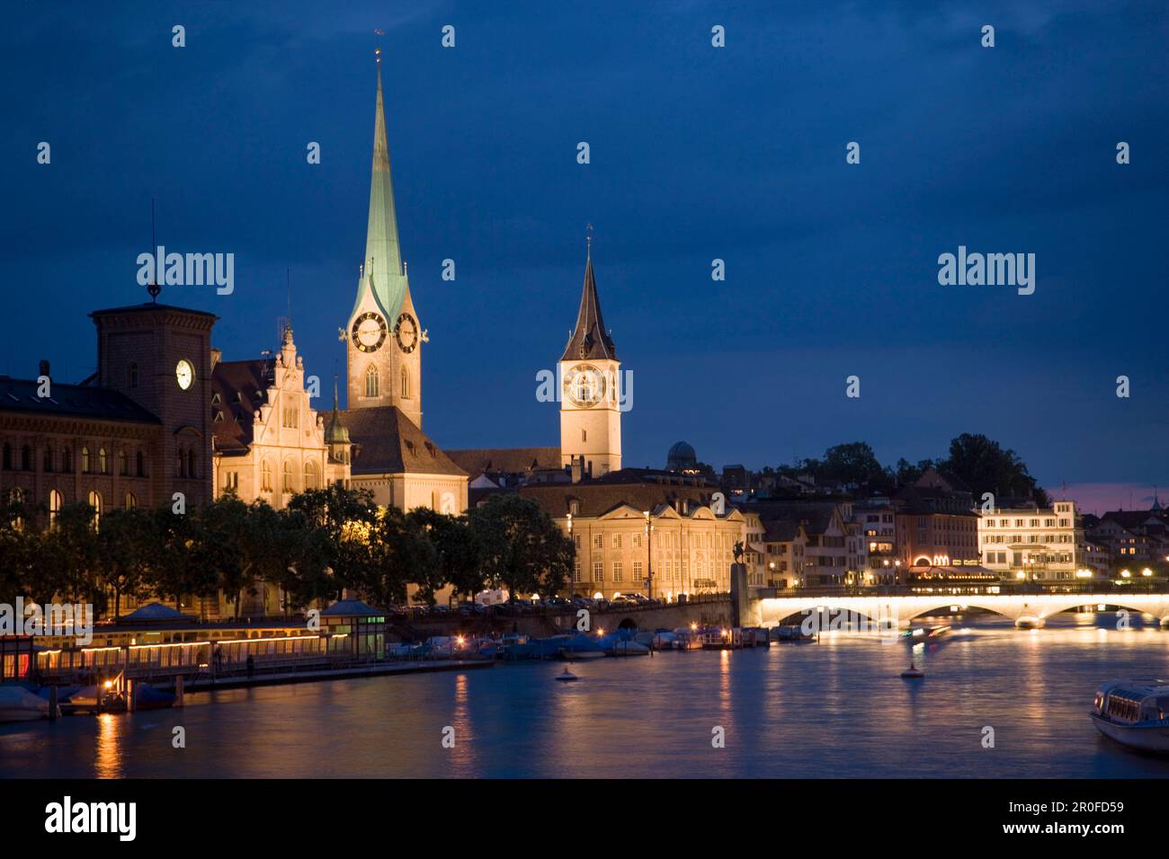 View over river Limmat to Fraumünster and St. Peter church at night, Zurich, Canton Zurich, Switzerland Stock Photo