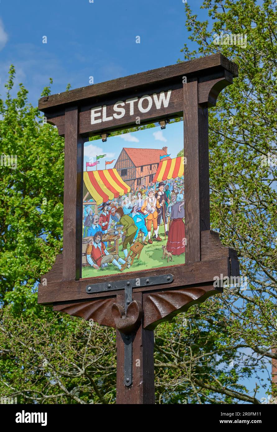 Elstow village sign, with old market scene in front of Moot Hall, on The Green, Elstow Stock Photo