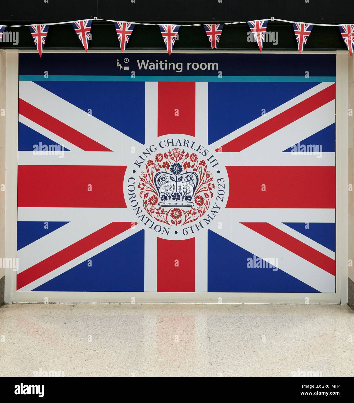 Union flag and coronation emblem over entrance to waiting room on councourse of Charing Cross station, London Stock Photo