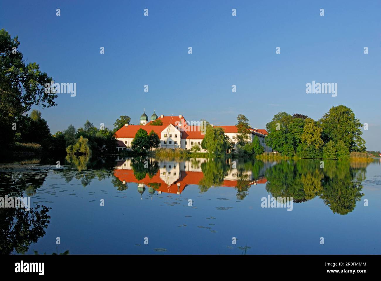 Seeon Abbey in Lake Seeon, Chiemgau, Upper Bavaria, Bavaria, Germany Stock Photo