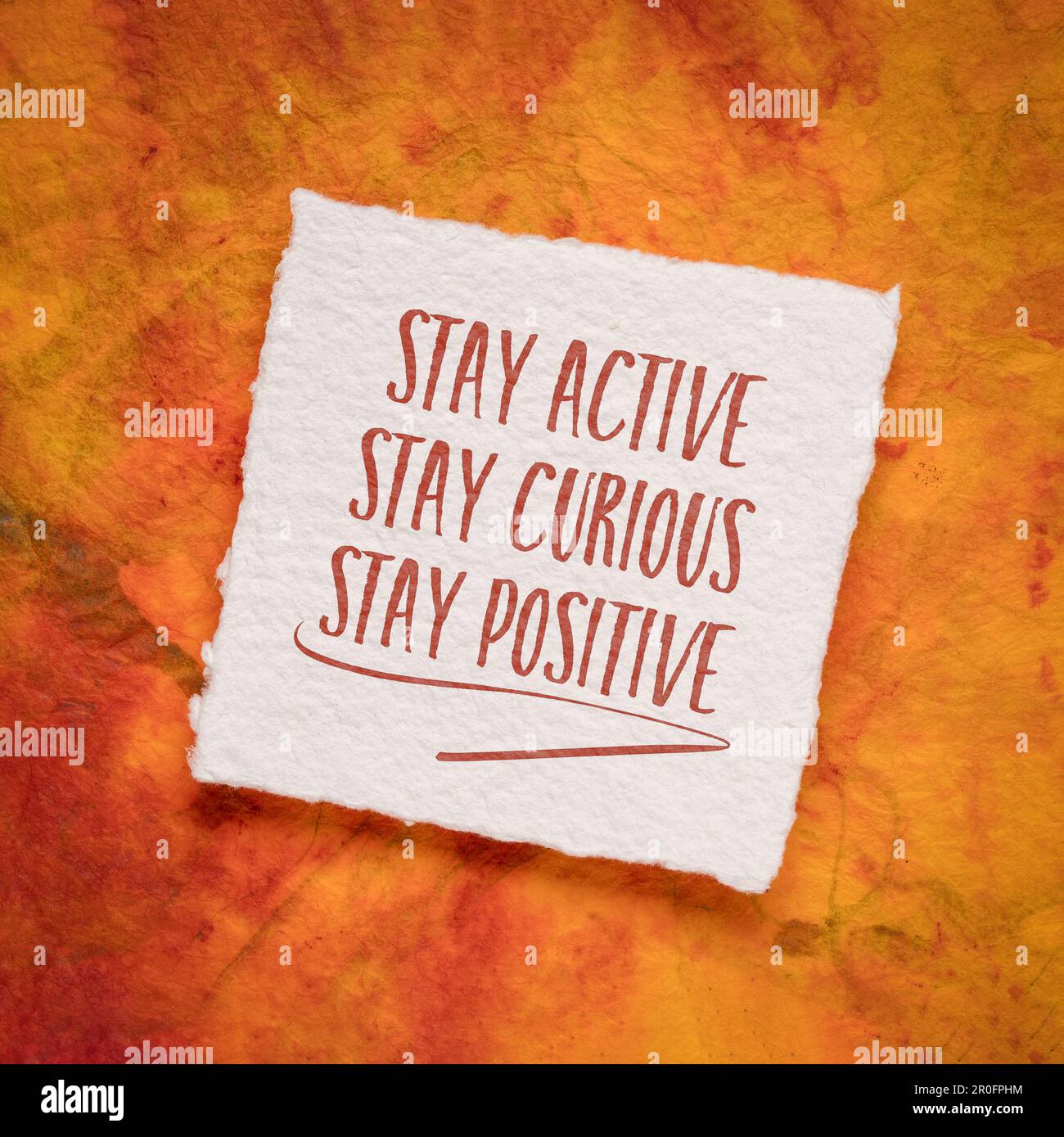 stay active, curious and positive - the keys to healthy aging, inspirational note on an art paper Stock Photo