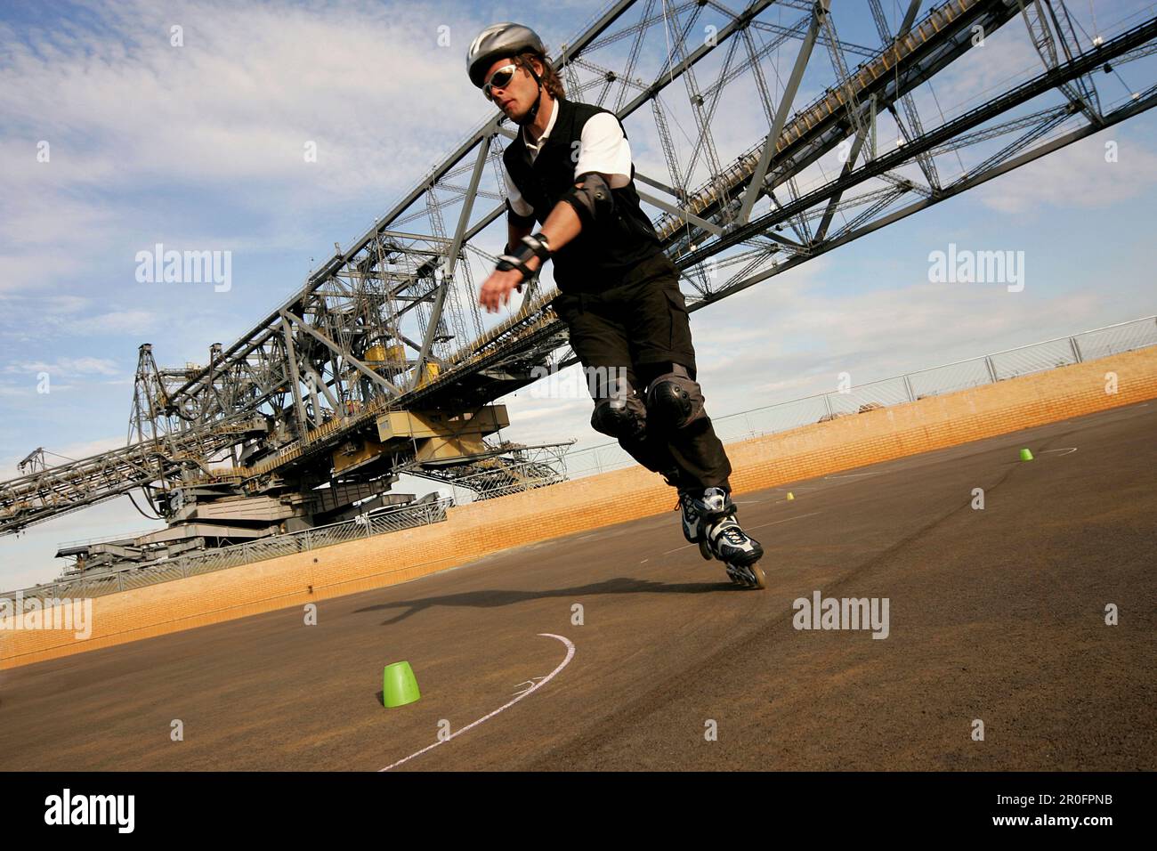 Man inline skating, overburden conveyor bridge F 60 in background