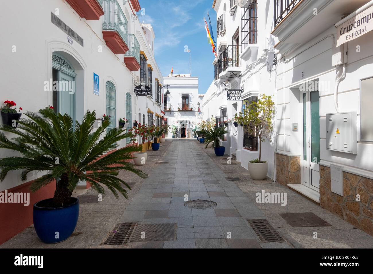 Chipiona, Cadiz, Spain - April 19, 2023: Nice street decorated with flowers pots in Chipiona, Andalusia, Southern Spain. Stock Photo