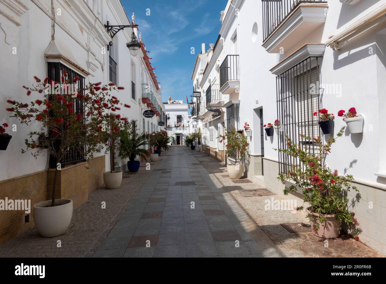 Chipiona, Cadiz, Spain - April 19, 2023: Nice street decorated with flowers pots in Chipiona, Andalusia, Southern Spain. Stock Photo