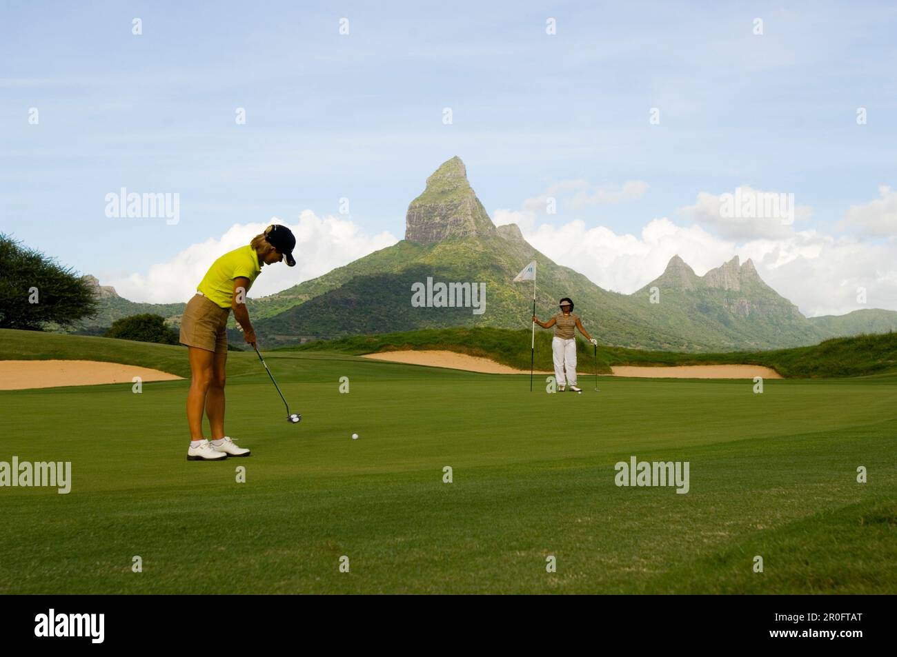 Woman playing golf on a golf course, Tamarin Golf Course, Mauritius, no MR Stock Photo