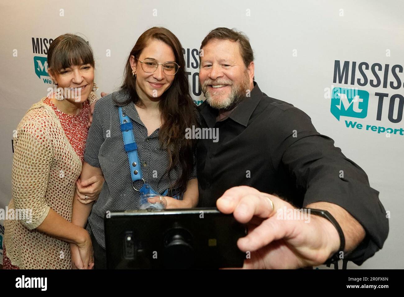Mississippi Today reporter Anna Wolfe, center, her mother, Bethel Wolfe, left, and father, Chris Wolfe, take a selfie photograph after receiving news that she won the 2023 Pulitzer Prize for Local Reporting,