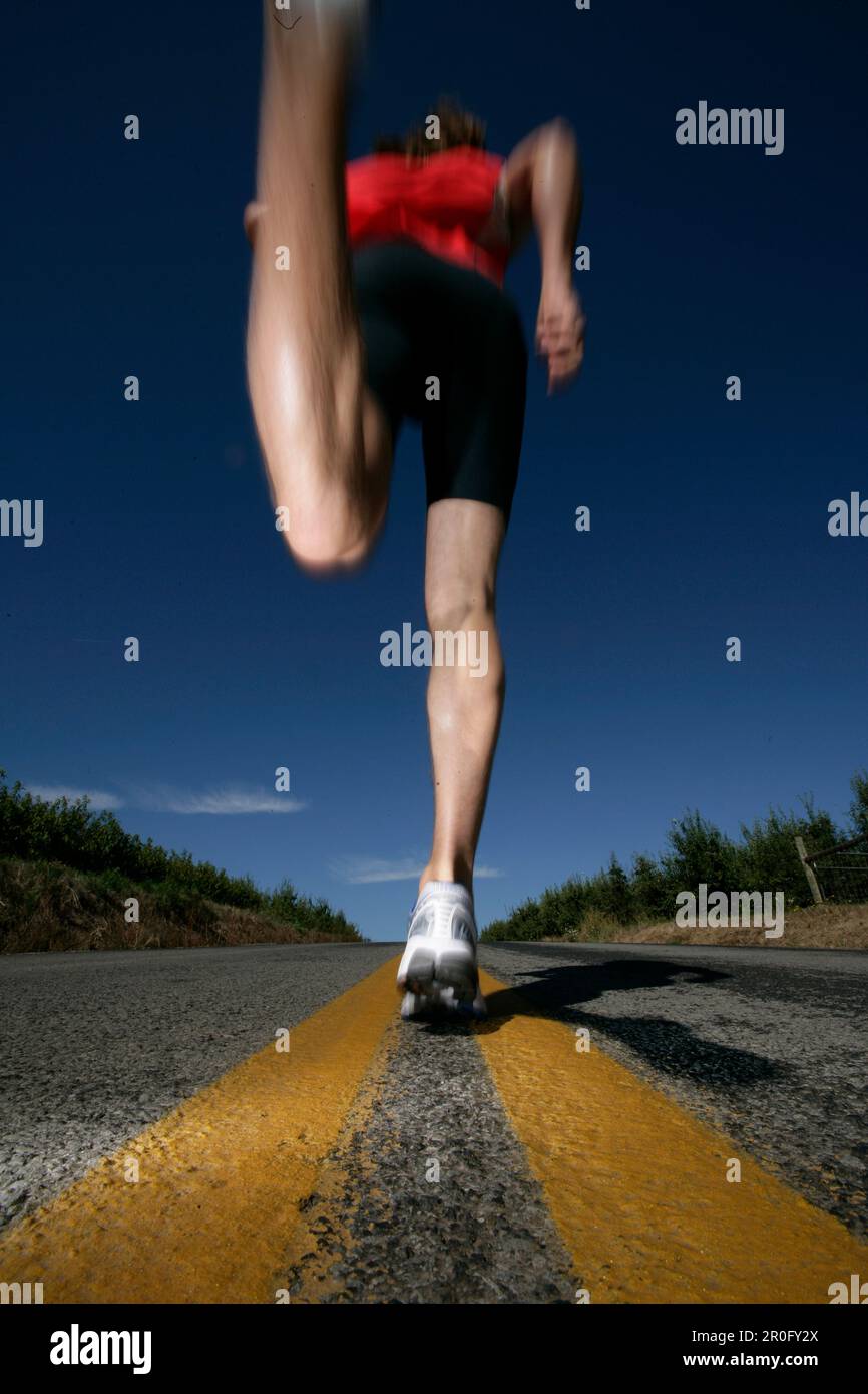Runner, man running on a country road near Mount Hood, from Mount Hood
