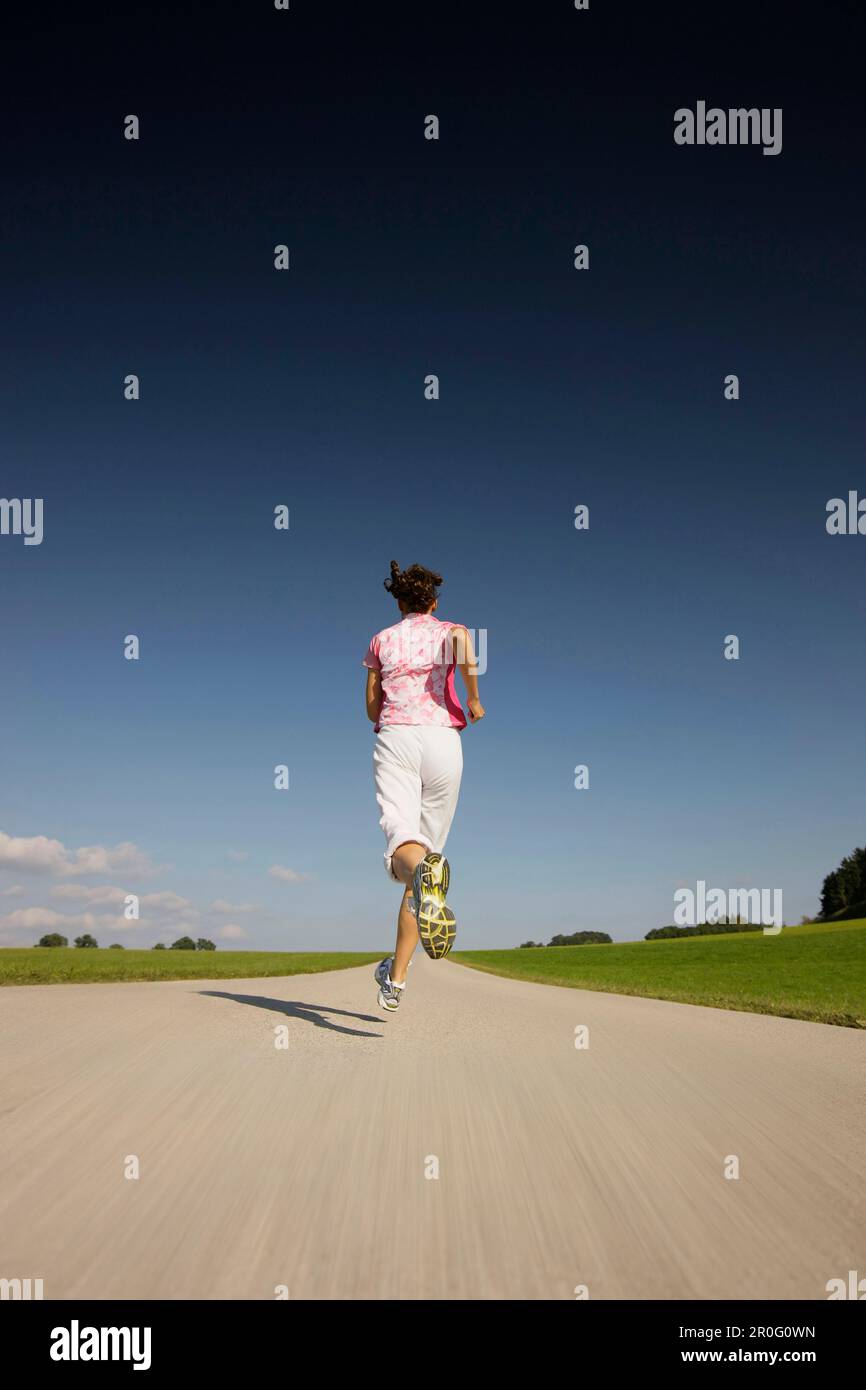 Woman jog street rear view hi-res stock photography and images - Alamy