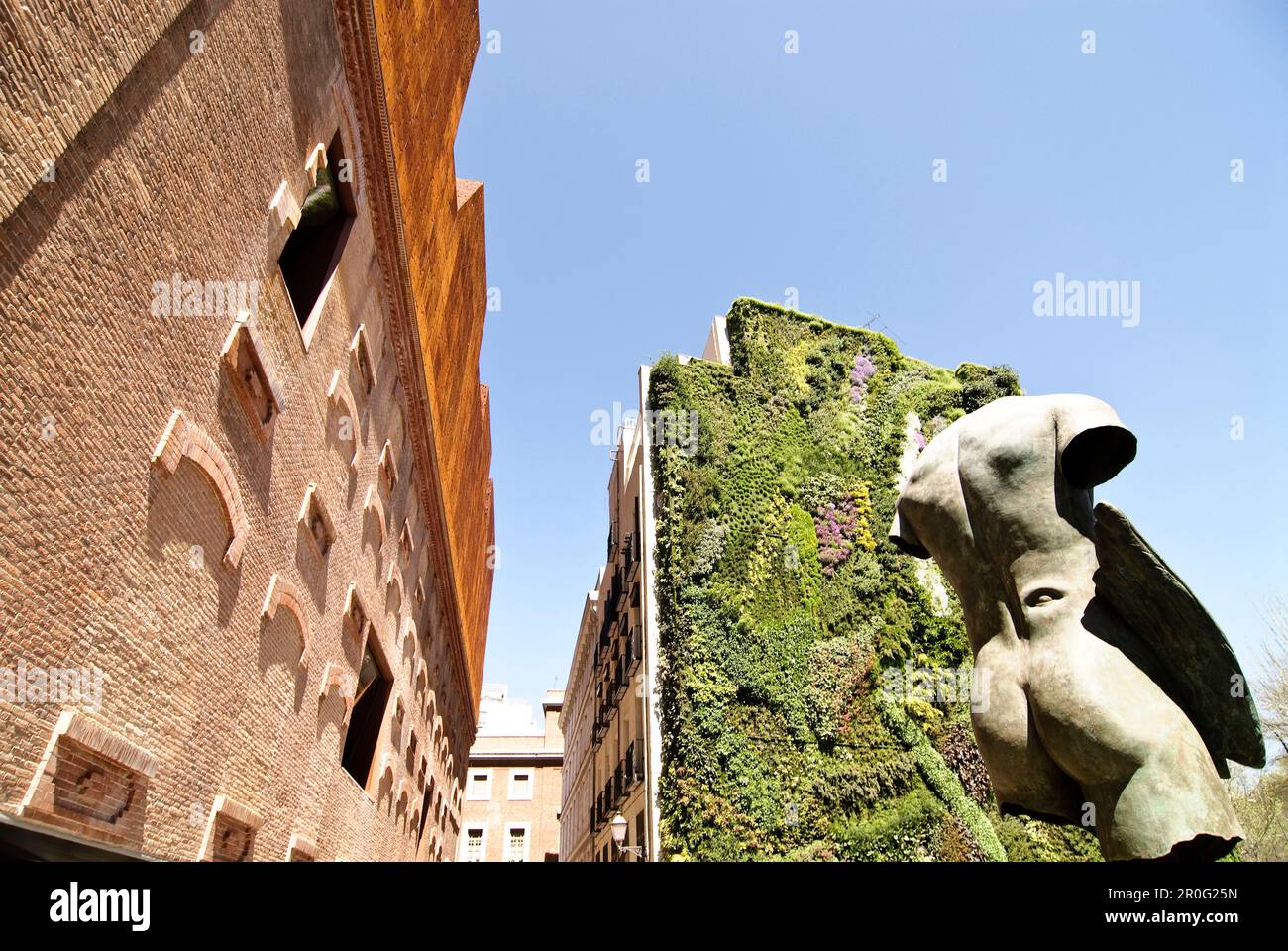 Caixa Forum, from architects Herzog & de Meuron, with sculpture from sculptur Igor Mitoraj, and vertical garden from Patrick Blanc, Madrid, Spain Stock Photo