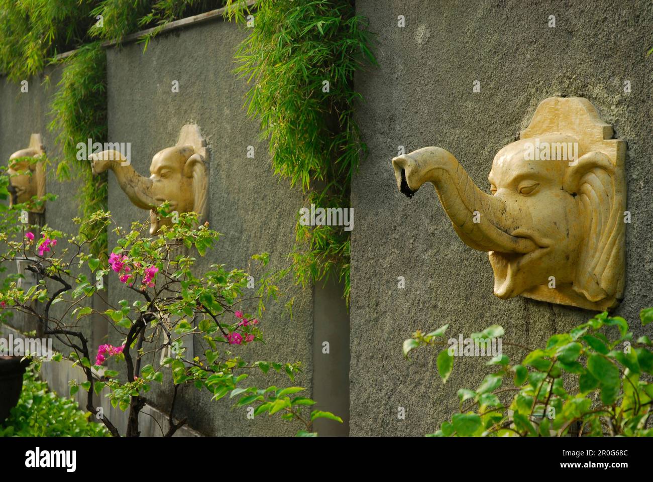 Wall with sculptures at the garden of Alam Kulkul Hotel, Kuta, Bali, Indonesia, Asia Stock Photo