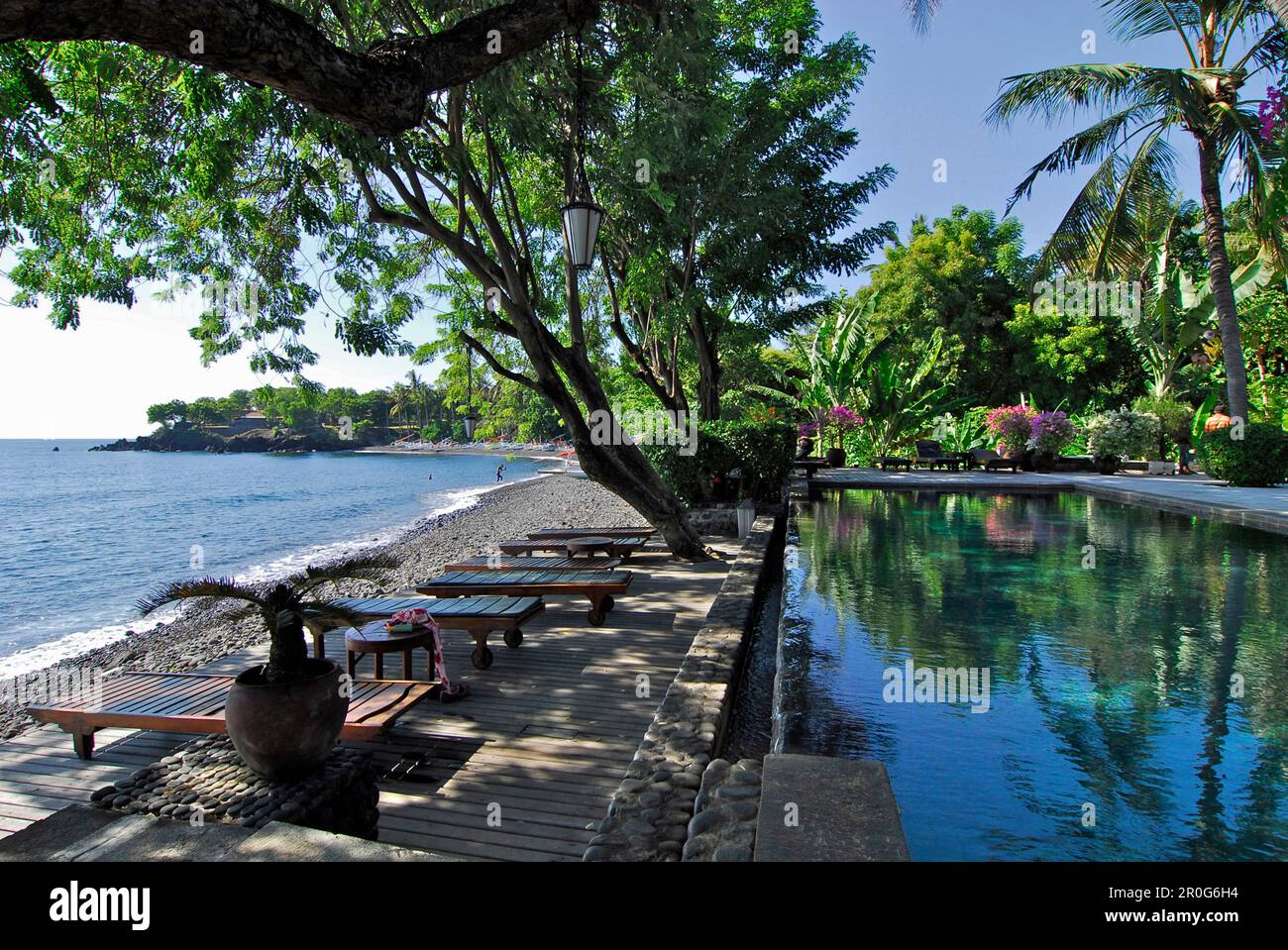 Deserted pool under palm trees at the beach, Mimpi Resort at Tulamben, North East Bali, Indonesia, Asia Stock Photo