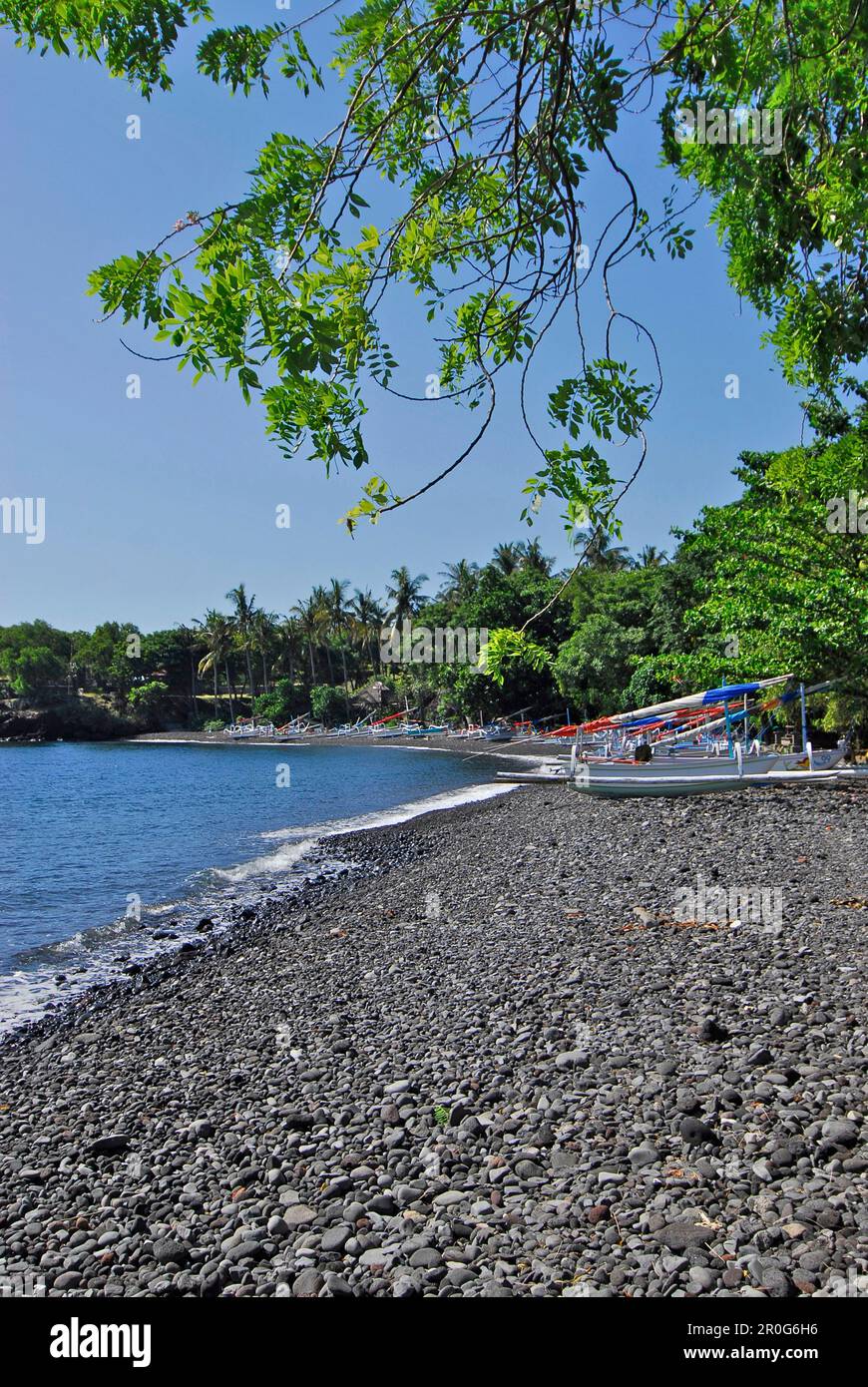 Boats lying on a stony beach under blue sky, Tulamben, East Bali, Indonesia, Asia Stock Photo