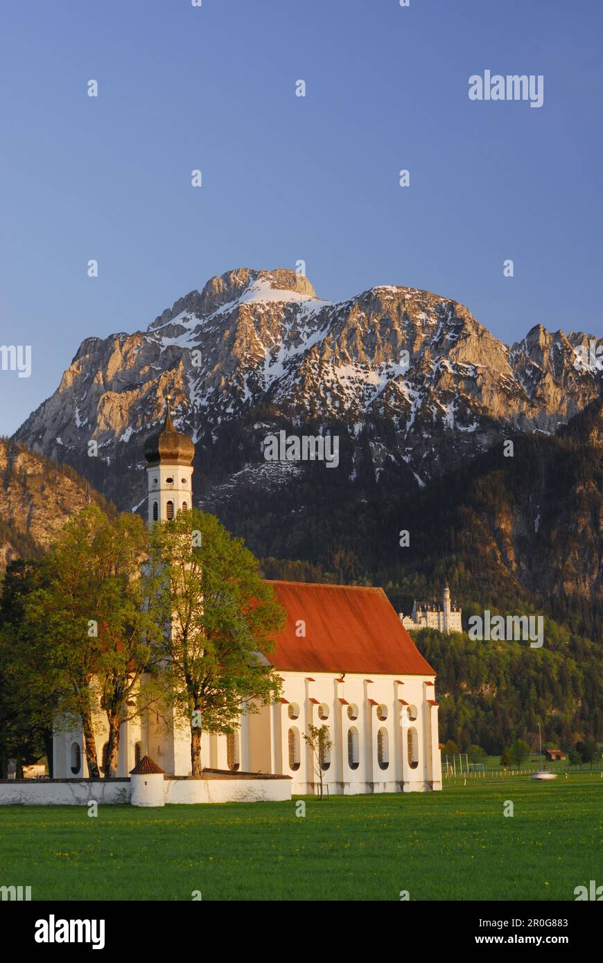 St. Coloman church with Neuschwanstein Castle, near Schwangau, Allgaeu ...