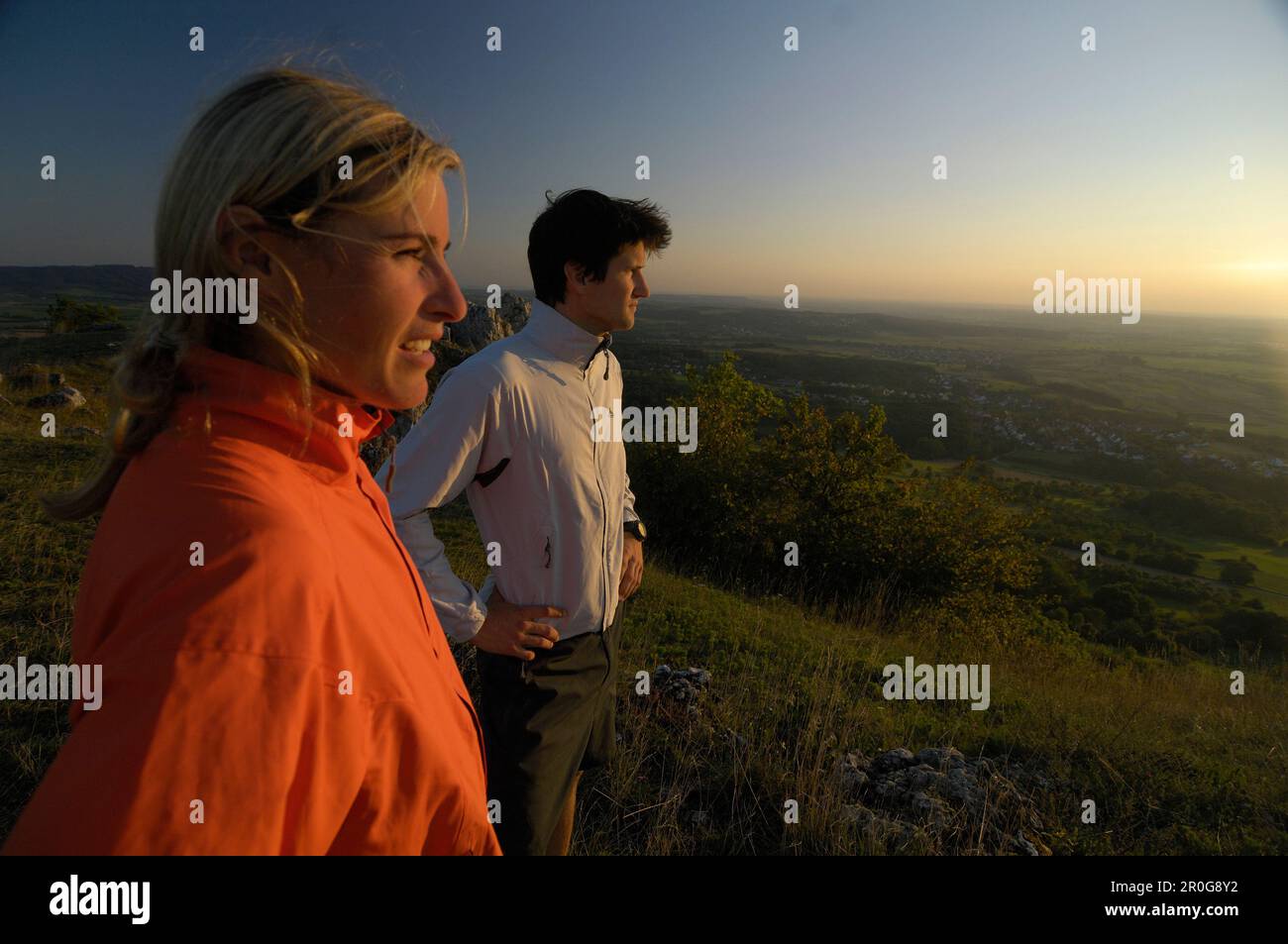Joggers looking at the view at dusk, Franconian Switzerland, Bavaria, Germany, Europe Stock Photo