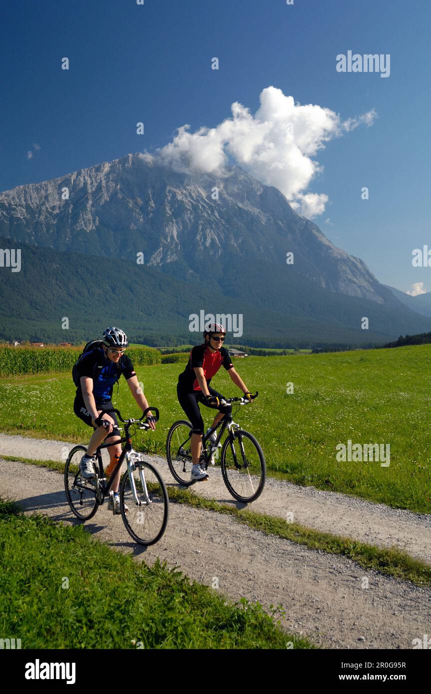 Couple on a mountain bike tour near Obermieming, near Telfs, Mieminger Plateau, Tyrol, Austria Stock Photo