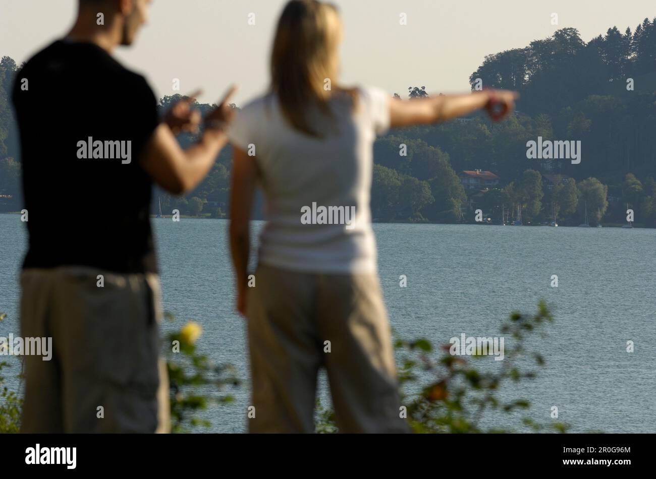 Couple at Lake Tegernsee, Woman is pointing her finger towards something, Lake Tegernsee, Upper Bavaria, Bavaria, Germany Stock Photo