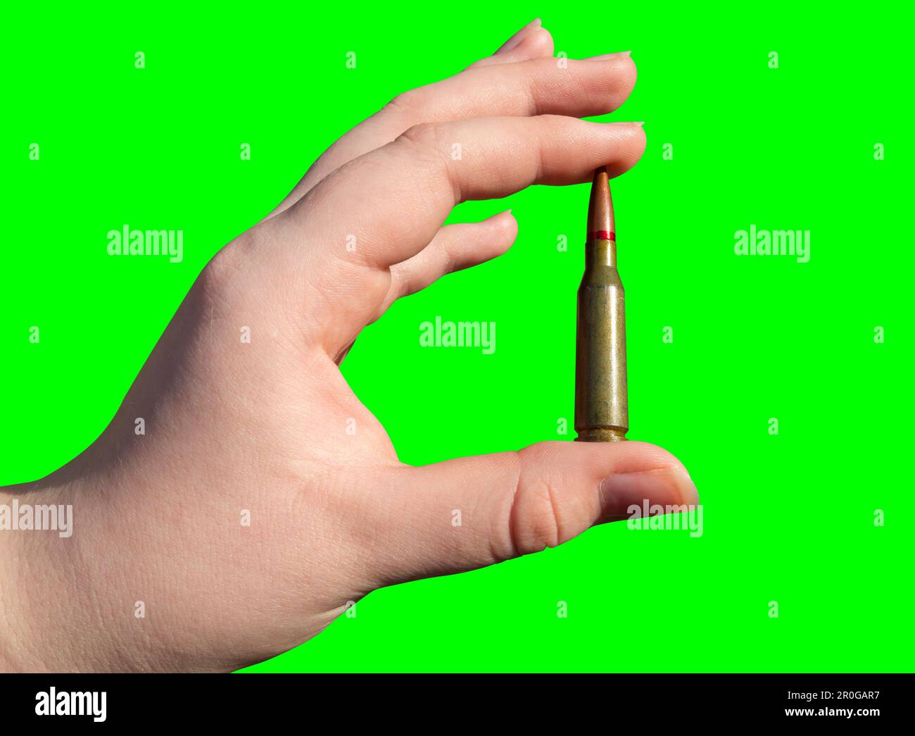 Rifle cartridge in hand on a green background (chroma key). Closeup