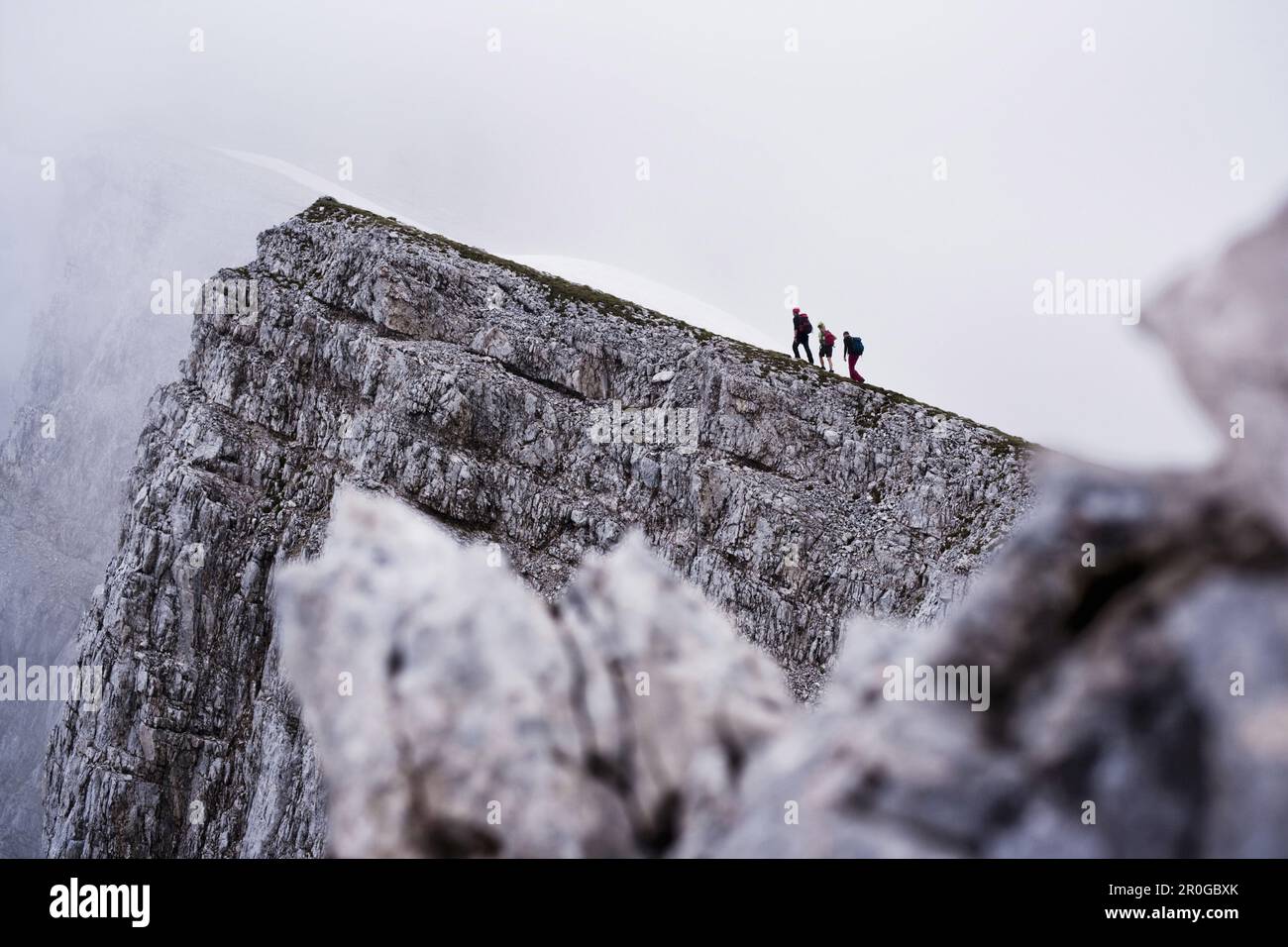 Three mountaineers ascending Sonntagkarspitze, Innsbruck, Karwendel range, Tyrol, Austria Stock Photo