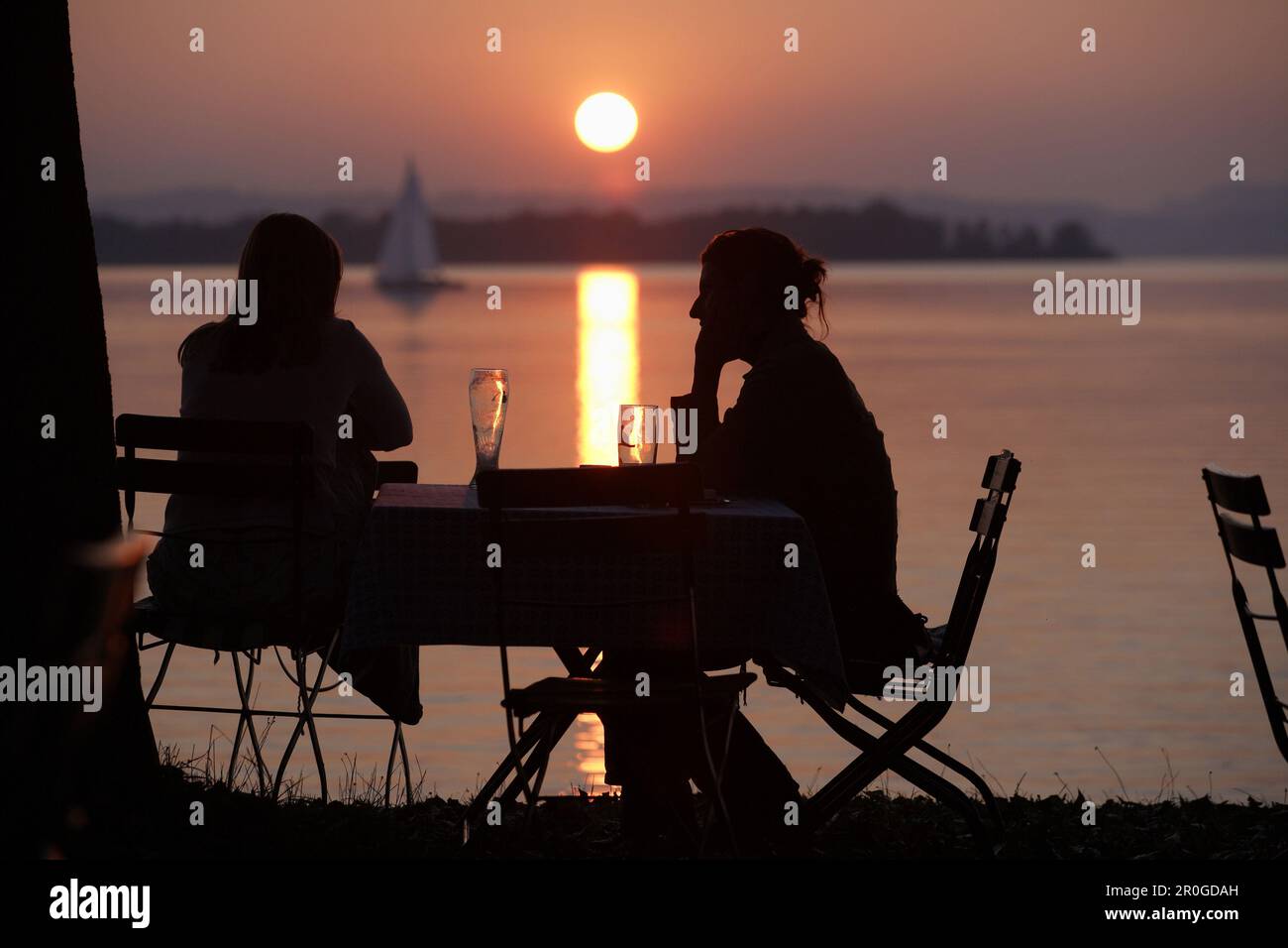 Two people in sunset, Feldwies, Lake Chiemsee, Chiemgau, Bavaria ...