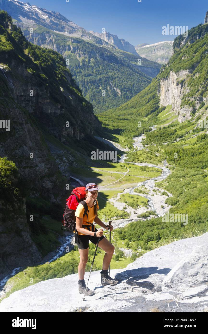 Woman hiking, Cirque Fer à Cheval, Haut Giffre, Rhone-Alpes, France Stock Photo