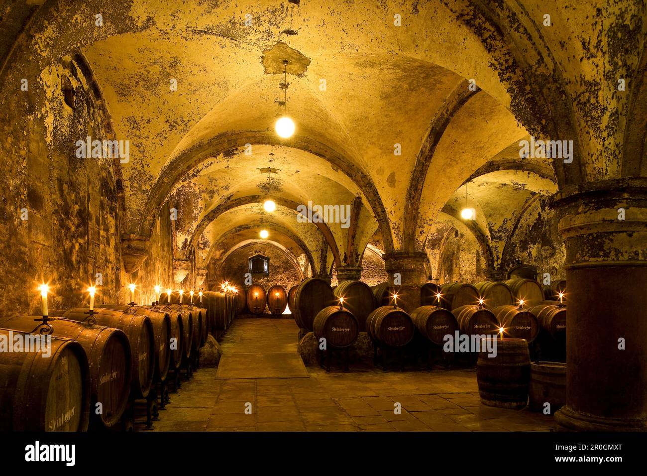 Candlelit barrels inside wine cellar of Eberbach abbey, a medieval monastery at Eltville am Rhein, Rheingau, Hesse, Germany, Europe Stock Photo