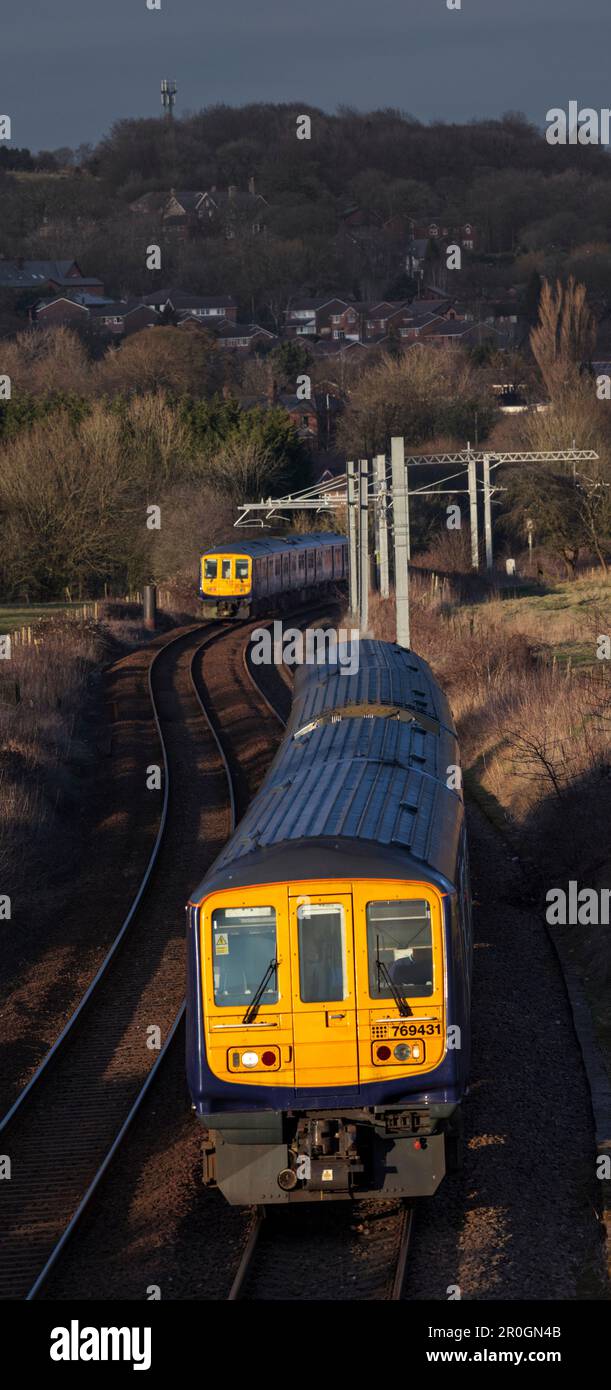 2 Northern Rail class 769 flex bi mode trains passing at Lostock junction, the end of the electrified section while running on diesel. Stock Photo